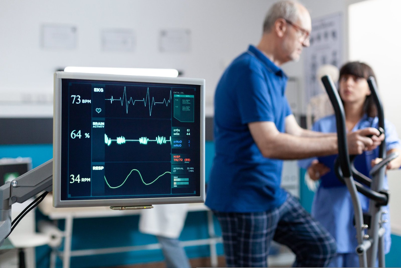 close-up-heart-rate-monitor-measuring-heartbeat-patient-doing-gymnastics-physical-recovery-retired-man-using-sport-equipment-exercise-physiotherapy-strength-min